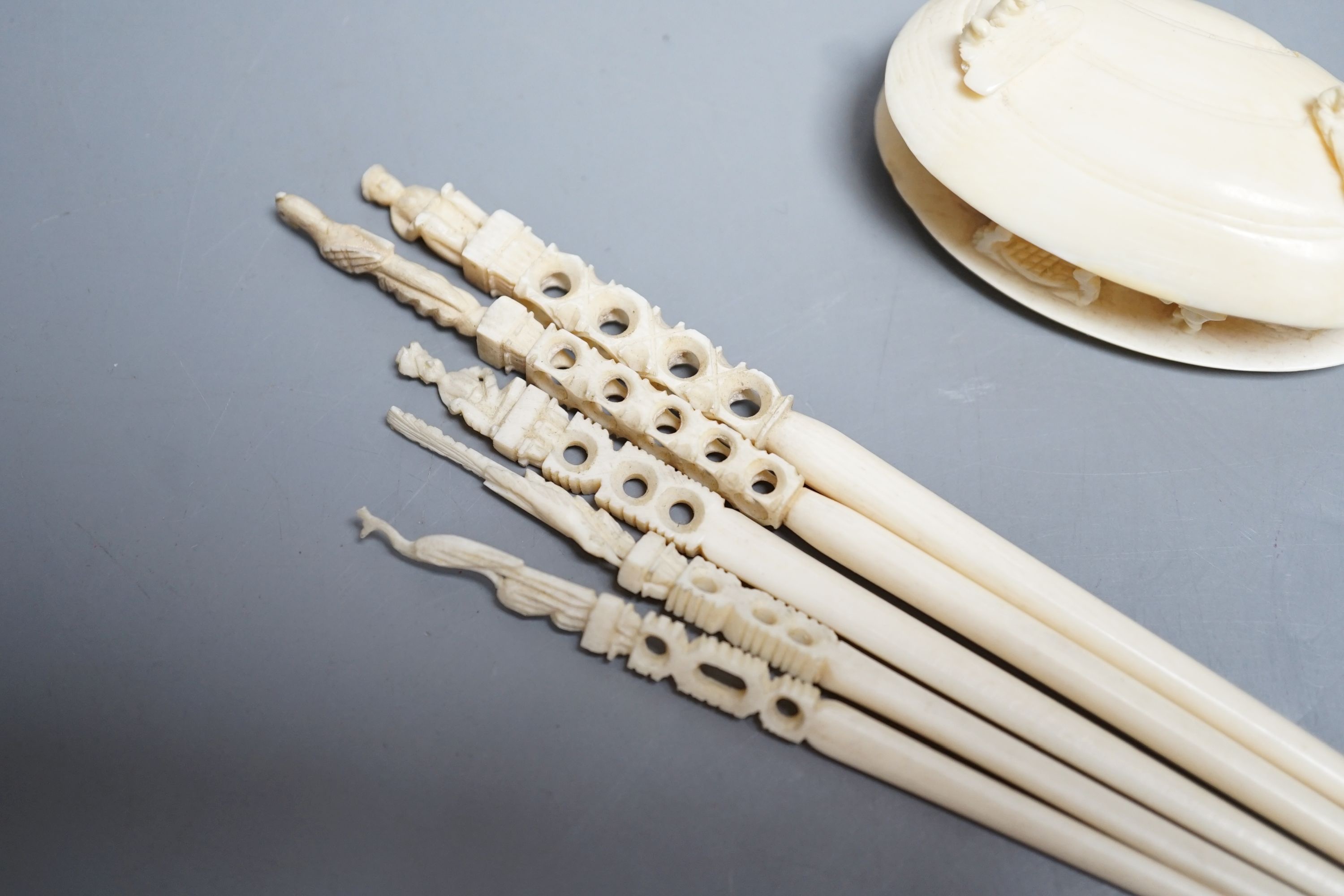 A Japanese ivory model of the clam's dream and five Indian ivory crochet hooks, late 19th/early 20th century